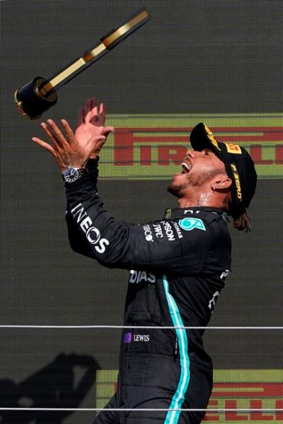 Mercedes driver Lewis Hamilton of Britain celebrates on the podium after winning the British Formula One Grand Prix, at the Silverstone circuit, in Silverstone, England, Sunday, July 18, 2021. (AP Photo/Jon Super)