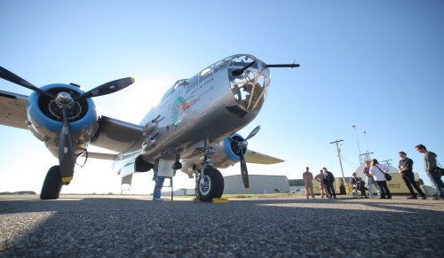 Matt Goerzen/The Brandon Sun
Brandon Sun A member of the flight ground crew for the Commemorative Air Force based out of Mesa, Ariz. preps a B-25J bomber for takeoff on Tuesday morning while invited guests and members of the media stand nearby, behind the Commonwealth Air Training Plan Museum at the Brandon Municipal Airport. The bomber - a Second World War aircraft nicknamed 