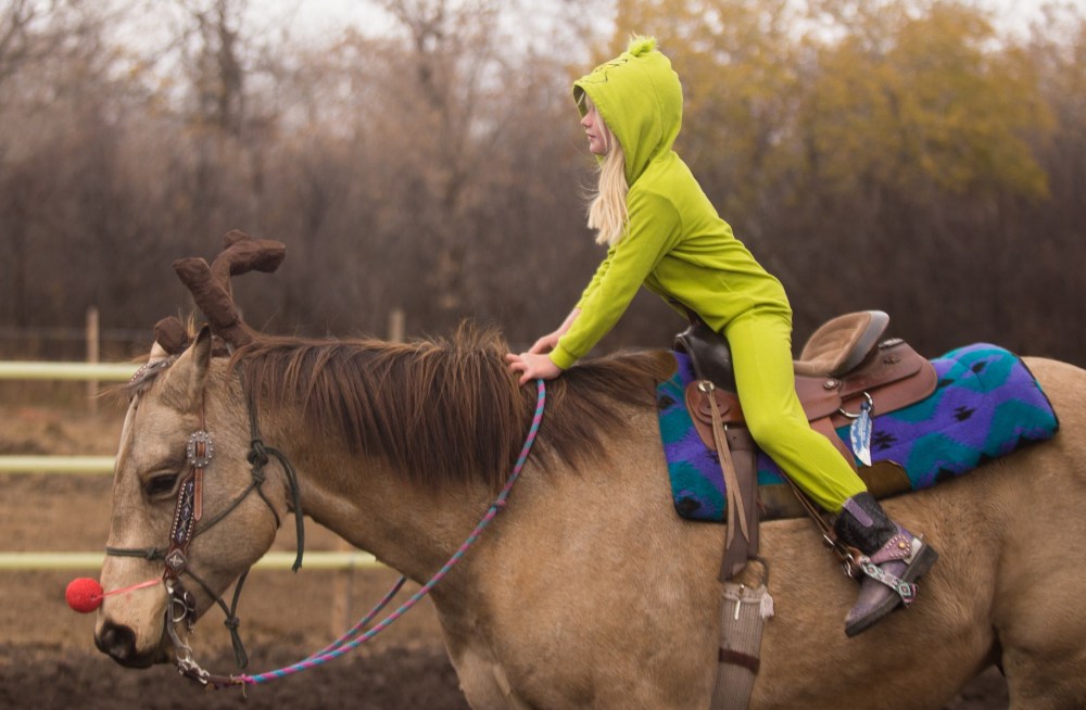 The Grinch Emerson Beernaerts, 8, and her trusty steed Rocky participate in the costume contest at the Lucky Break Ranch Halloween Jackpot Race Sunday. (Chelsea Kemp/The Brandon Sun)