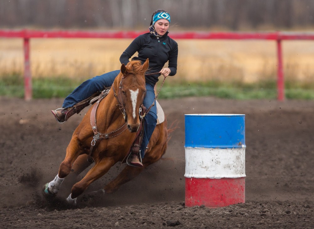 Katie Wright, 16, and her horse Chic whip around a barrel at the Lucky Break Ranch Halloween Jackpot Race Sunday. (Chelsea Kemp/The Brandon Sun)