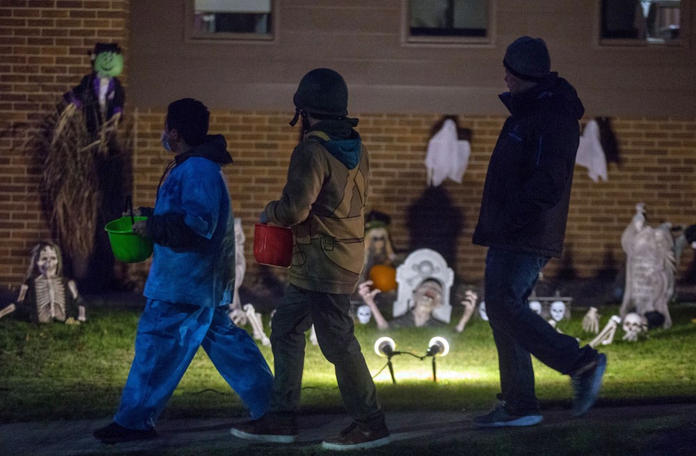 Trick-or-treaters make their way down Rosser Avenue Sunday celebrating Halloween. (Chelsea Kemp/The Brandon Sun)