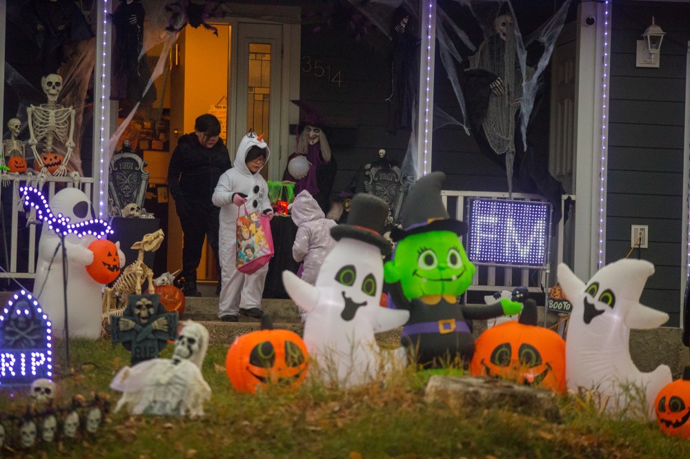 Boston Boucher, 7, celebrates Halloween at a house on Rosser Avenue Sunday. (Chelsea Kemp/The Brandon Sun)