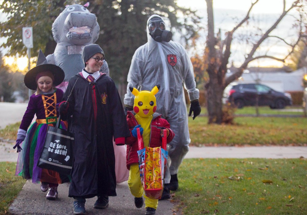 The Reid family makes their way down Rosser Avenue Sunday celebrating Halloween. (Chelsea Kemp/The Brandon Sun)
