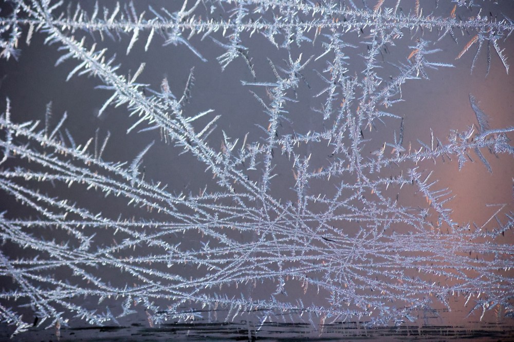 Delicate patterns of frost that formed on my porch windows overnight on Monday are seen here against the light from the house next door. (Matt Goerzen/The Brandon Sun)