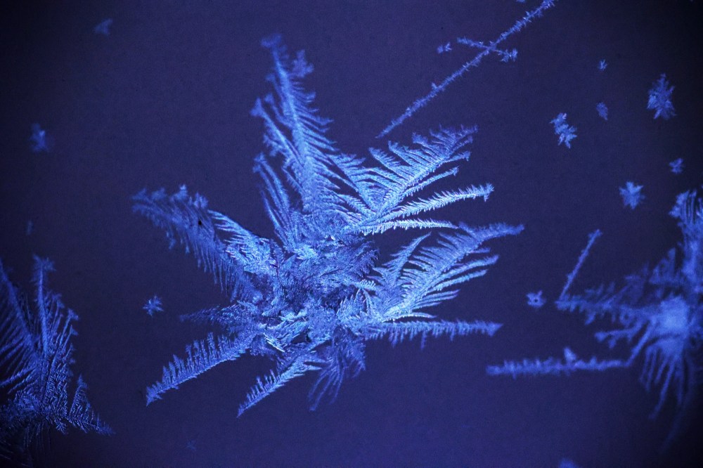 Patterns of frost that formed on my porch windows overnight on Monday are seen here against the light from the house next door. (Matt Goerzen/The Brandon Sun)