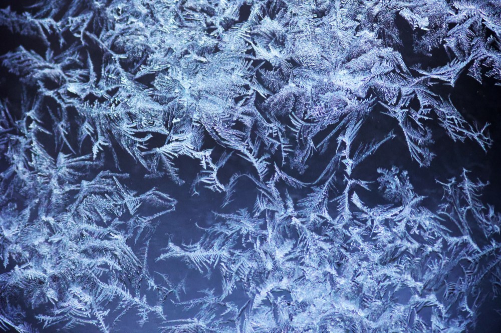 Patterns of frost that formed on my porch windows overnight on Monday are seen here against the light from the house next door. (Matt Goerzen/The Brandon Sun)
