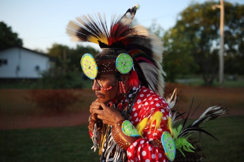 Quentin PJ Tootoosis, of Poundmaker First Nation, finishes putting on his regalia prior to the Sioux Valley Dakota Nation Powwow Friday evening. (Tim Smith/The Brandon Sun)