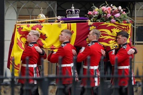 Pallbearers carry the coffin of Queen Elizabeth II, draped in the Royal Standard with the Imperial State Crown during her State Funeral at Westminster Abbey in London, Monday, Sept. 19, 2022. The Queen, who died aged 96 on Sept. 8, will be buried at Windsor alongside her late husband, Prince Philip, who died last year. THE CANADIAN PRESS/AP-James Manning/Pool Photo via AP