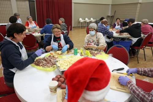 Paula Stirling, Kim McKee and Gerry Gebhardt peel and dice potatoes on Friday alongside other volunteers helping prepare for the Westman and Area Traditional Christmas Dinner at the Keystone Centre. (Tim Smith/The Brandon Sun)