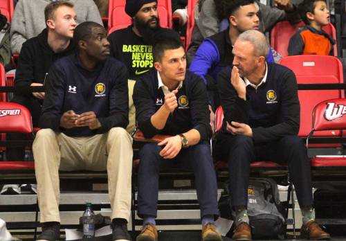 Brandon University men's basketball assistant coaches O'Neil Gordon, from left, Derek Barnett and Brett Nohr discuss a play during their game against the Winnipeg Wesmen on Thursday. (Thomas Friesen/The Brandon Sun)