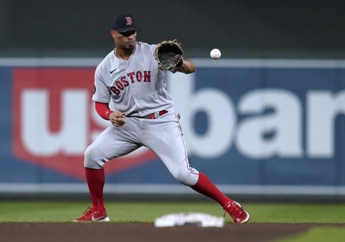 FILE - Boston Red Sox's Xander Bogaerts fields the ball hit by Minnesota Twins' Luis Arraez during the fifth inning of a baseball game Aug. 31, 2022, in Minneapolis. The San Diego Padres and Bogaerts agreed to a blockbuster $280 million, 11-year contract Wednesday night, Dec. 7, adding the All-Star slugger to an already deep lineup. A person familiar with the negotiations confirmed the contract to The Associated Press on condition of anonymity because it was pending a physical. (AP Photo/Abbie Parr, File)