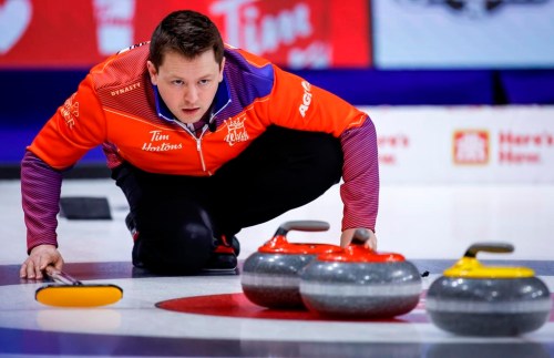 Team Wild Card Three skip Jason Gunnlaugson directs his teammates while playing Team Northwest Territories at the Tim Hortons Brier in Lethbridge, Alta., Tuesday, March 8, 2022. Reid Carruthers' curling team and vice-skip Jason Gunnlaugson have split up. THE CANADIAN PRESS/Jeff McIntosh