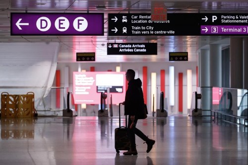 Travellers make their way through Pearson International Airport in Toronto Monday, Nov. 14, 2022. Ottawa plans to temporarily require people flying from China, Hong Kong and Macao to test negative for COVID-19 before leaving for Canada, beginning in early January. THE CANADIAN PRESS/Cole Burston