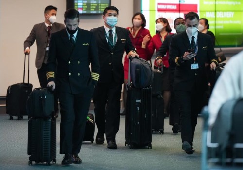 Cathay Pacific crew members who worked on a flight from Hong Kong arrive at Vancouver International Airport, in Richmond, B.C., on Wednesday, January 4, 2023. The Canadian government announced last week that the travellers would need a negative test administered within 48 hours of their departure as cases soar in China. THE CANADIAN PRESS/Darryl Dyck