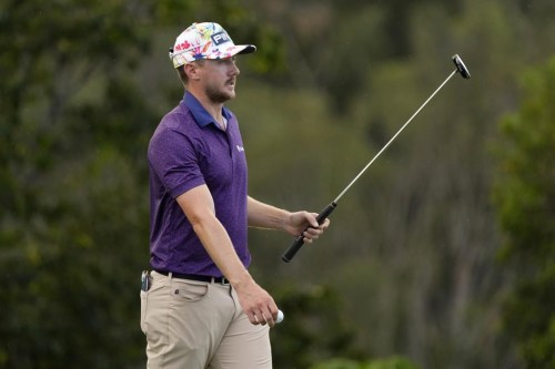 Mackenzie Hughes acknowledges the gallery after his shot on the 17th green during the first round of the Tournament of Champions golf event, Thursday, Jan. 5, 2023, at Kapalua Plantation Course in Kapalua, Hawaii. (AP Photo/Matt York)