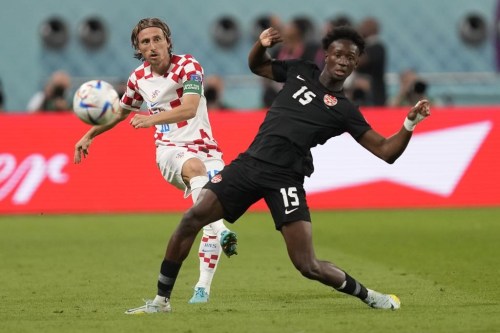 Croatia's Luka Modric, left, pass the ball past Canada's Ismael Kone during the World Cup group F soccer match between Croatia and Canada, at the Khalifa International Stadium in Doha, Qatar, Sunday, Nov. 27, 2022. Canadian international midfielder Ismael Kone made his debut for Watford in a 2-0 loss to Reading in a third-round game in England's FA Cup on Saturday. Kone played the full 90 minutes in the matchup of teams from England's second-tier Championship. THE CANADIAN PRESS/AP, Darko Vojinovic