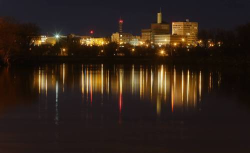 The Brandon skyline is reflected on the Assiniboine River. Madelyn Robinson says: “Instead of providing private parkland for some, let’s work toward a climate resilient, caring community that makes services for all a priority.”