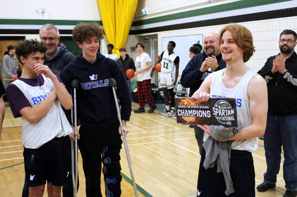 Mike McDougall, left, laughs as his teammate Jackson Doak poses for photos following the Selkirk Royals 86-54 win over the Linden Christian Wings in the Brandon Sun Spartan Invitational Tier 2 final. (Lucas Punkari/The Brandon Sun)