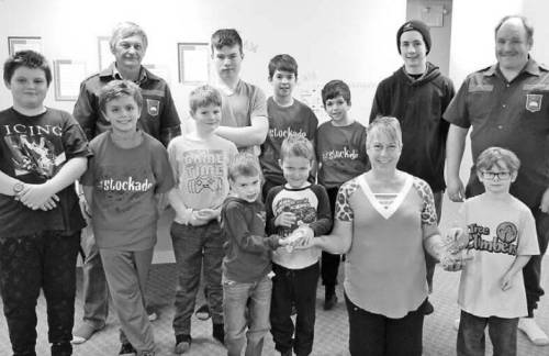 Raymond Dyck, Daxton Brock, Caleb Laliberte, Matthew Laliberte, Ethan Laliberte, Andrew Gugin, Mason Veltri, Sammy Pacheco, Soren Brock, Douglas Burgess, Hunter White and Jaxon Barnesky presented $130 to Carol Brown, chairperson of the Minnedosa and Area Food Bank. (Minnedosa Tribune)