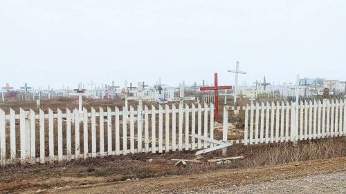 A graveyard in Tuktoyaktuk. (Ollie Williams/Cabin Radio)