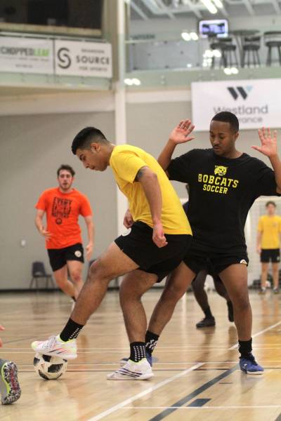 Camilo Rodriguez dribbles while Jordan Dill defends during Brandon University Bobcats men’s futsal practice on Tuesday. (Thomas Friesen/The Brandon Sun)