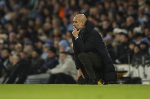 Manchester City's head coach Pep Guardiola watches during the English FA Cup soccer match between Manchester City and Chelsea at the Etihad Stadium in Manchester, England, Sunday, Jan. 8, 2023. (AP Photo/Dave Thompson)