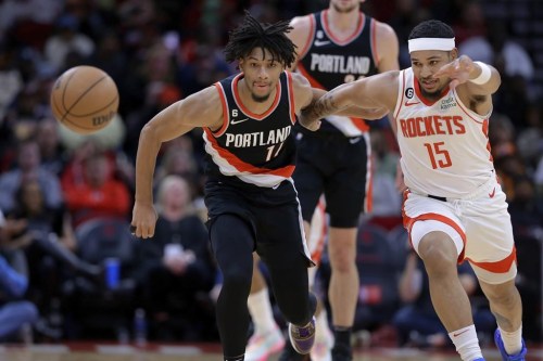 Portland Trail Blazers guard Shaedon Sharpe (17) and Houston Rockets guard Daishen Nix (15) scramble for a loose ball during the second half of an NBA basketball game Saturday, Dec. 17, 2022, in Houston. While an air of mystery surrounded Canadian Shaedon Sharpe around the 2022 NBA draft, the Portland Trail Blazers guard is certainly a secret no longer. Sharpe played in Canada as a pro for the first time on Sunday as the Toronto Raptors hosted Portland, and Trail Blazers coach Chauncey Billups had kind words for his 19-year-old rookie from London, Ont. THE CANADIAN PRESS/AP, Michael Wyke