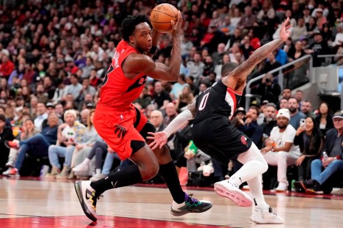 Toronto Raptors forward O.G. Anunoby (3) draws a foul against Portland Trail Blazers guard Damian Lillard (0) during second half NBA basketball action in Toronto on Sunday, Jan. 8, 2023. THE CANADIAN PRESS/Frank Gunn