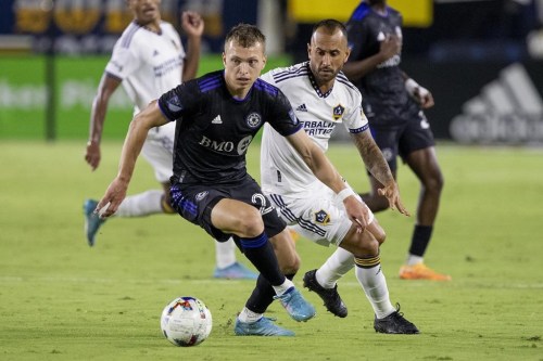 CF Montreal defender Alistair Johnston, left, takes the ball away from LA Galaxy midfielder Victor Vazquez during the second half of an MLS soccer match in Carson, Calif., Monday, July 4, 2022. THE CANADIAN PRESS/AP-Alex Gallardo