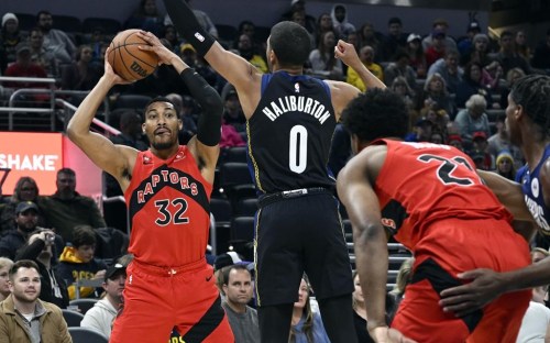 Toronto Raptors forward Otto Porter Jr. (32) looks to pass the ball away from Indiana Pacers guard Tyrese Haliburton (0) during the first quarter of an NBA basketball game, Saturday, Nov. 12, 2022, in Indianapolis, Ind. Porter will miss the remainder of the 2022-23 season after undergoing surgery on his left foot. THE CANADIAN PRESS/AP-Marc Lebryk