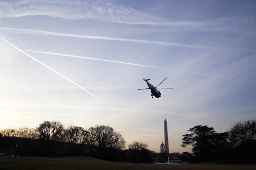 The sky is filled with contrails as Marine One, with President Joe Biden and first lady Jill Biden on board, lifts off from the South Lawn of the White House in Washington, Wednesday, Jan. 11, 2023. They are heading to Walter Reed National Military Medical Center where Jill Biden is having surgery to remove a small lesion found above her right eye during a routine skin cancer screening. (AP Photo/Susan Walsh)