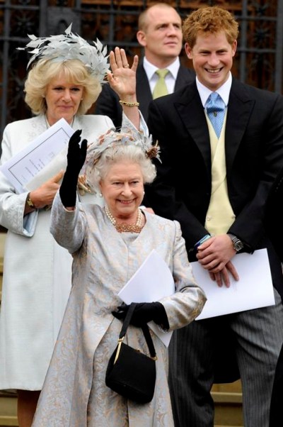 FILE - Britain's Queen Elizabeth II, with Prince Harry and Camilla, Duchess of Cornwall, waves to her eldest grandson Peter Phillips and wife Autumn Kelly as they leave St. George's Chapel in Windsor, England, after their marriage ceremony, May 17, 2008. Prince Harry’s explosive memoir, with its damning allegations of a toxic relationship between the monarchy and the press, is likely to accelerate the pace of change already under way within the House of Windsor following the death of Queen Elizabeth II. (AP Photo/Ian McIlgorm, Pool, File)