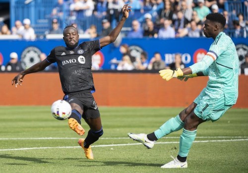 CF Montréal forward Kei Kamara (23) moves in on New York City goalkeeper Sean Johnson (1) during first half Eastern Conference semifinals MLS playoff soccer action in Montreal, Sunday, October 23, 2022. Kamara has requested a trade from Montreal after contract negotiations fell through.THE CANADIAN PRESS/Graham Hughes