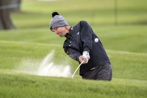 Michael Gligic, of Canada, hits out of a bunker on the eighth green during the first round of the RSM Classic golf tournament, Thursday, Nov. 17, 2022, in St. Simons Island, Ga. Gligic has only taken a few days off since his last PGA Tour event in November. He's been working hard — even getting reps in during a heavy snowfall in Kitchener, Ont., — for the resumption of play this month. THE CANADIAN PRESS/AP/Stephen B. Morton