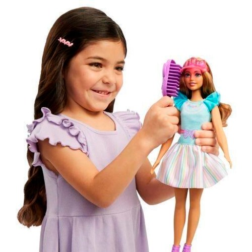 This image released by Mattel shows a child playing with Teresa, a My First Barbie, a new doll made specifically for children as young as 3. It is 13.5 inches tall, with a broader waste that de-emphasizes the bust line, with flesh-tone modesty undergarments permanently attached. (Mattel via AP)