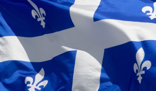 Quebec's provincial flag flies on a flag pole in Ottawa on June 30, 2020. Municipal officials say workers are missing after an explosion at a propane facility in St-Roch-de-l'Achigan, Que. Provincial police say evacuations are underway in the town north of Montreal. THE CANADIAN PRESS/Adrian Wyld