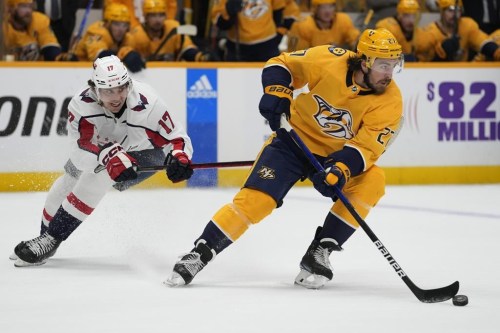 Nashville Predators' Ryan McDonagh (27) moves the puck ahead of Washington Capitals' Dylan Strome (17) in the first period of an NHL hockey game Saturday, Oct. 29, 2022, in Nashville, Tenn. THE CANADIAN PRESS/AP Photo/Mark Humphrey