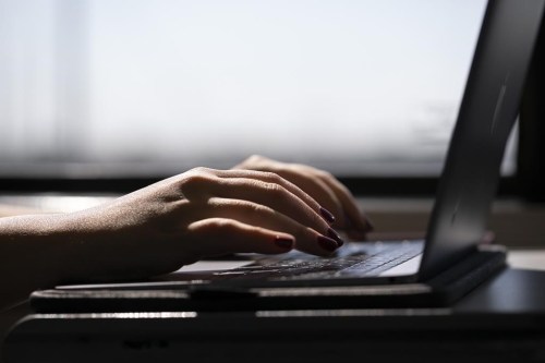 A person types on a laptop in New Jersey, May 18, 2021. THE CANADIAN PRESS/AP-Jenny Kane