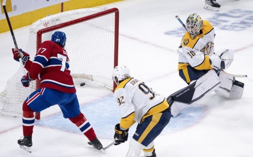 Montreal Canadiens' Kirby Dach scores past Nashville Predators goaltender Yaroslav Askarov as Predators' Ryan Johansen looks on during first period NHL hockey action in Montreal, on Thursday, January 12, 2023. THE CANADIAN PRESS/Paul Chiasson