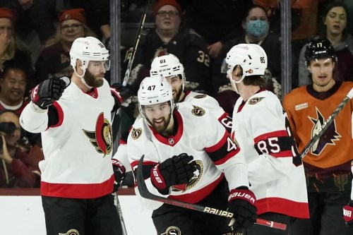 Ottawa Senators center Mark Kastelic (47) smiles as he celebrates his goal against the Arizona Coyotes with left wing Austin Watson (16), center Derick Brassard (61) and defenseman Jake Sanderson (85) as Coyotes center Nick Bjugstad (17) pauses on the ice during the third period of an NHL hockey game in Tempe, Ariz., Thursday, Jan. 12, 2023. (AP Photo/Ross D. Franklin)